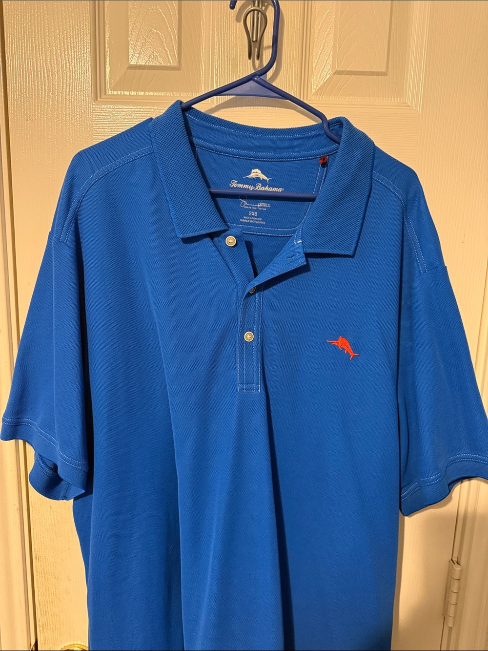 Tommy Bahama Blue Polo with Orange Dolphin Emblem